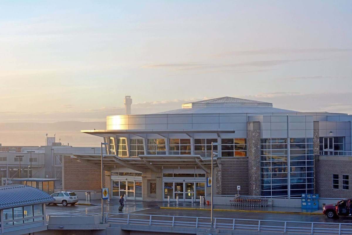 Boise Airport during sunrise with blue and pink skies behind building